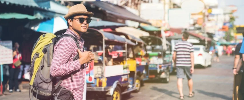 Man walking streets in Bangkok, Thailand on holiday