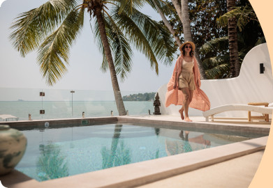 Woman walking next to a pool on holidays