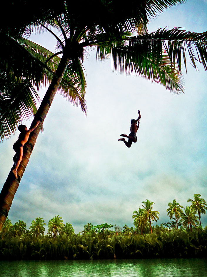 Cover-More New Zealand Facebook photo competition winner: Children jumping off coconut tree into water in the Philippines