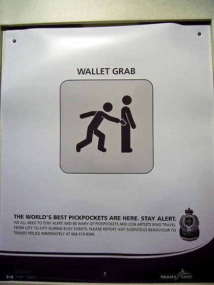 A public advertisement brings attention to pickpockets in the area and warns tourists and locals alike to stay alert.
