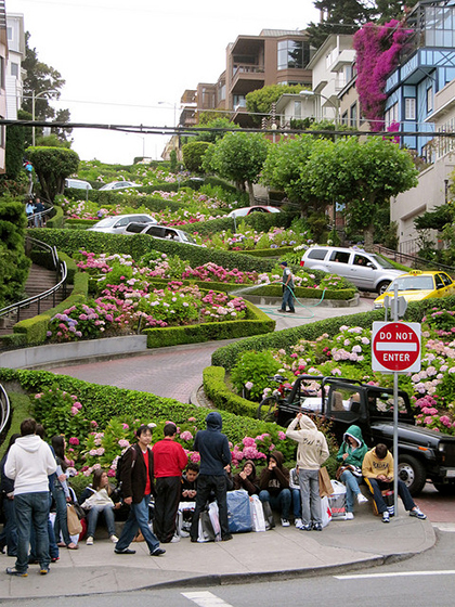 At the bottom of Lombard Street’s zig-zag pattern with a number of cars navigating the sharp turns.