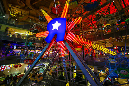The massive ferris wheel in NYC’s Toys ‘R’ Us gives riders a unique perspective on the immense toy store.