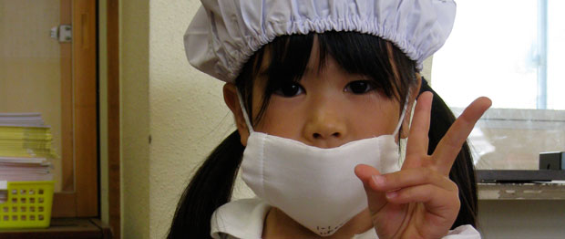 A young girl in a germ mask