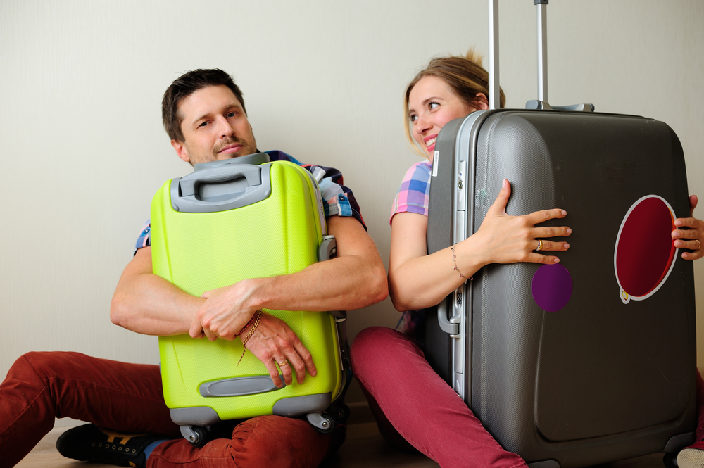 Man and Woman protecting suitcases