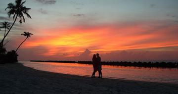 Couple on beach at sunset